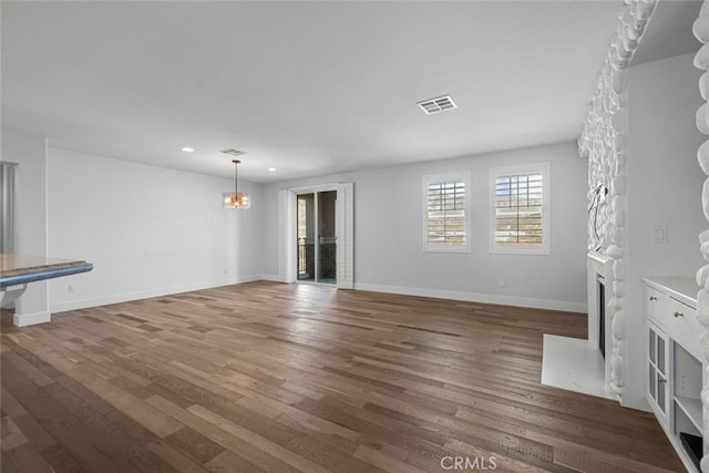 unfurnished living room with dark hardwood / wood-style floors