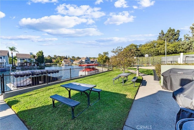 view of home's community featuring a yard and a water view