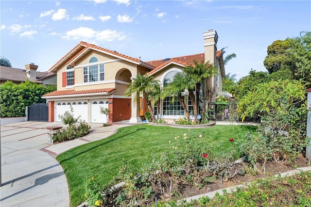 mediterranean / spanish home featuring a front yard and a garage