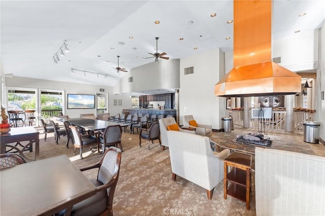 living room with ceiling fan, rail lighting, and high vaulted ceiling