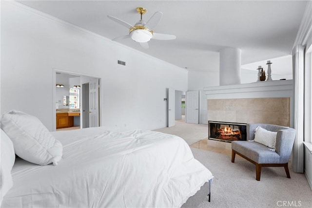 bedroom featuring light colored carpet, ceiling fan, crown molding, and ensuite bathroom