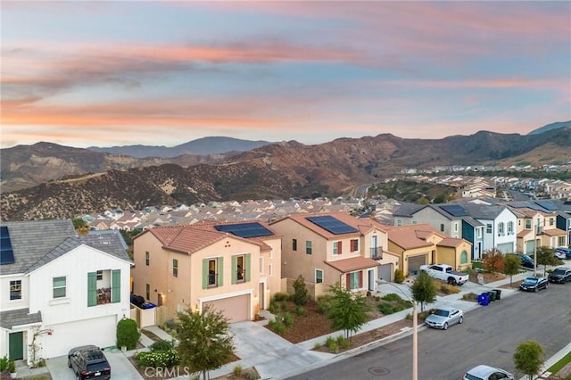 aerial view at dusk featuring a mountain view