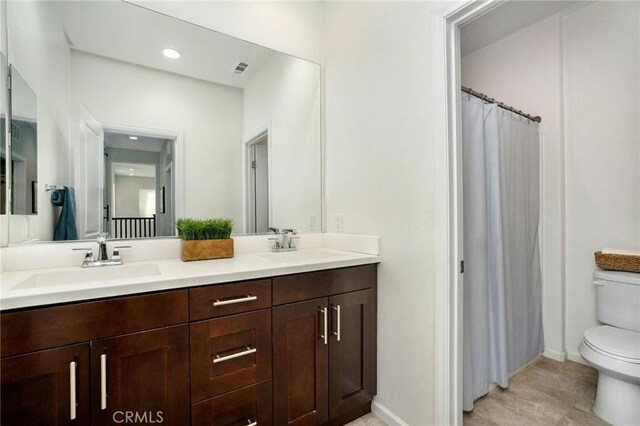 bathroom with tile patterned floors, vanity, and toilet