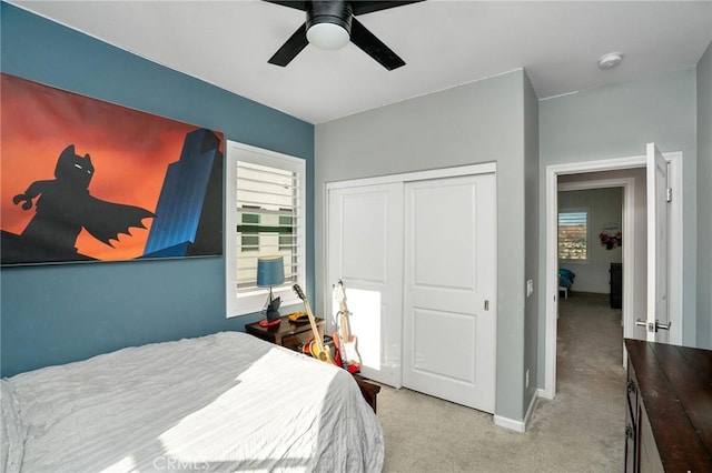 bedroom featuring light carpet, a closet, and ceiling fan