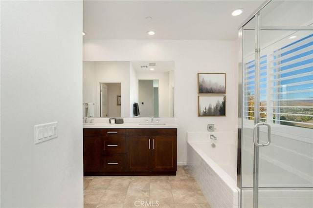 bathroom with tile patterned flooring, vanity, and shower with separate bathtub