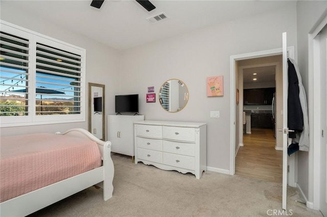 bedroom with ceiling fan and light colored carpet