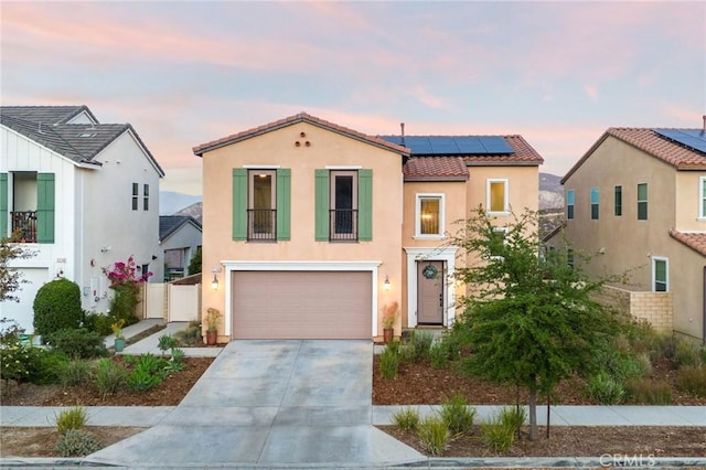 view of front facade featuring a garage and solar panels