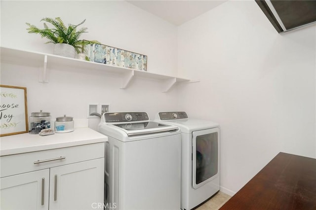 washroom featuring light tile patterned floors, cabinets, and independent washer and dryer