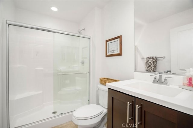 bathroom featuring vanity, toilet, and an enclosed shower