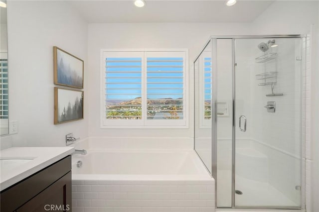 bathroom with vanity and independent shower and bath