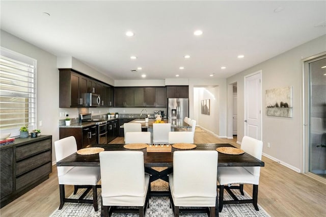 dining area featuring light hardwood / wood-style flooring and sink