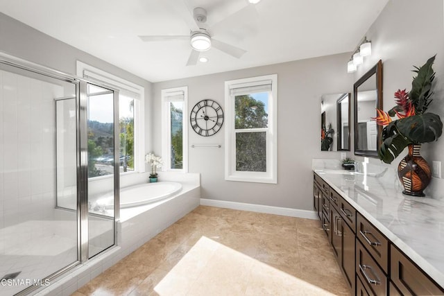 bathroom with vanity, shower with separate bathtub, a wealth of natural light, and ceiling fan