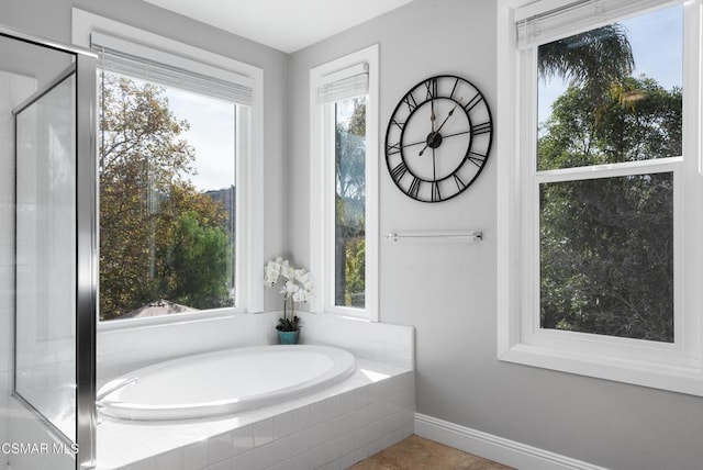 bathroom featuring independent shower and bath