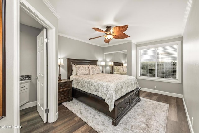 bedroom featuring dark wood-type flooring, ceiling fan, ensuite bathroom, and crown molding