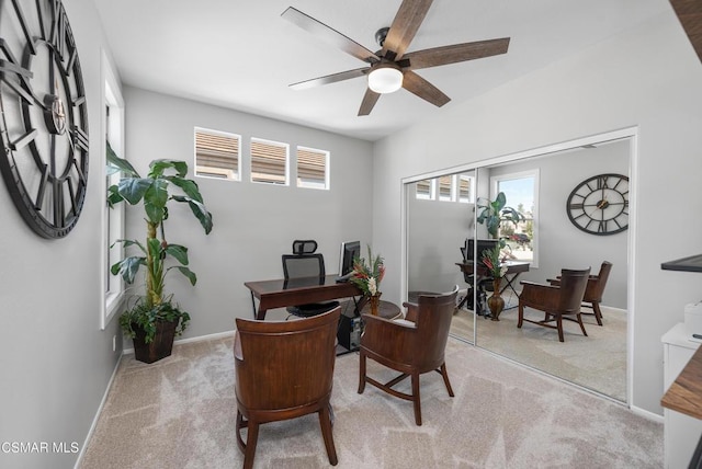 home office featuring light colored carpet and ceiling fan