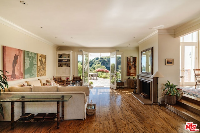 living room featuring wood-type flooring and ornamental molding