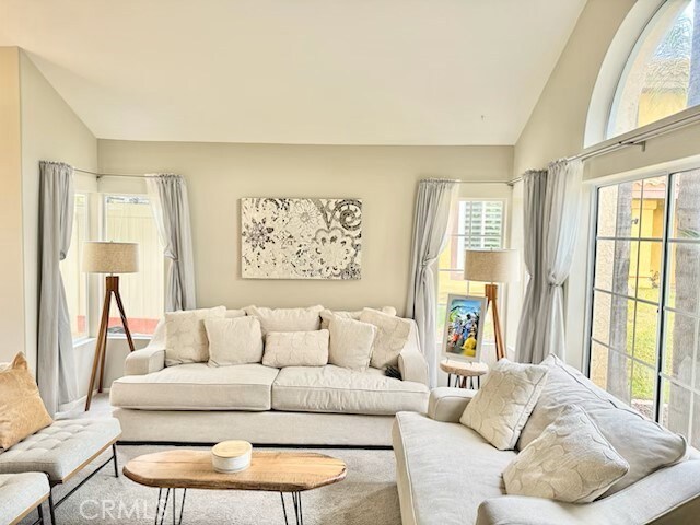 living room with plenty of natural light and lofted ceiling