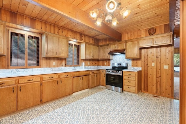 kitchen with wood walls, wooden ceiling, ventilation hood, stainless steel range, and beam ceiling