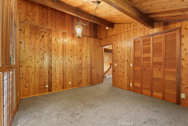 interior space featuring vaulted ceiling with beams, wooden ceiling, and wood walls