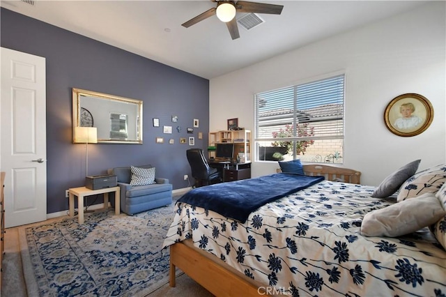 bedroom with ceiling fan and wood-type flooring