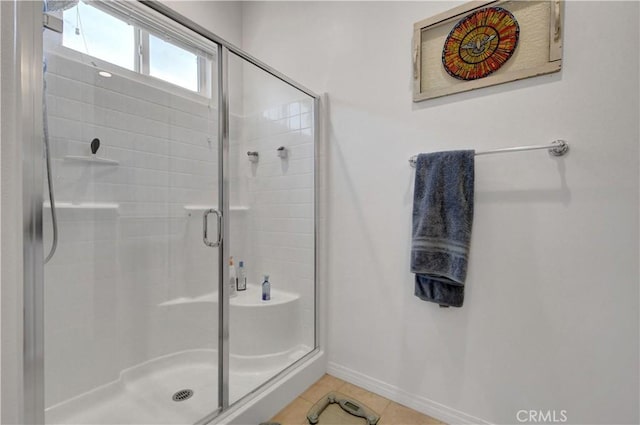 bathroom featuring an enclosed shower and tile patterned flooring