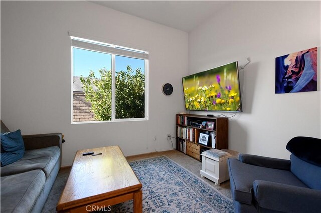 living room with light carpet and a healthy amount of sunlight