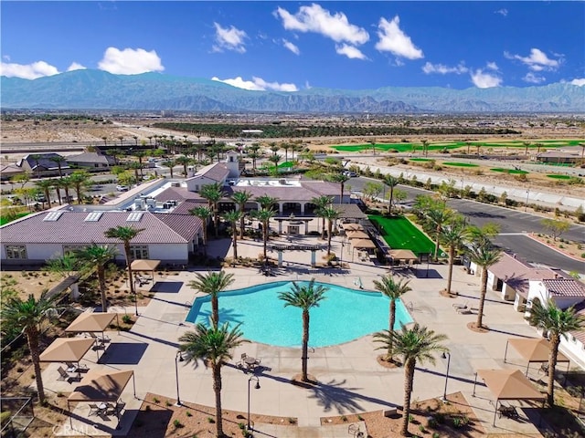 view of pool featuring a mountain view and a patio