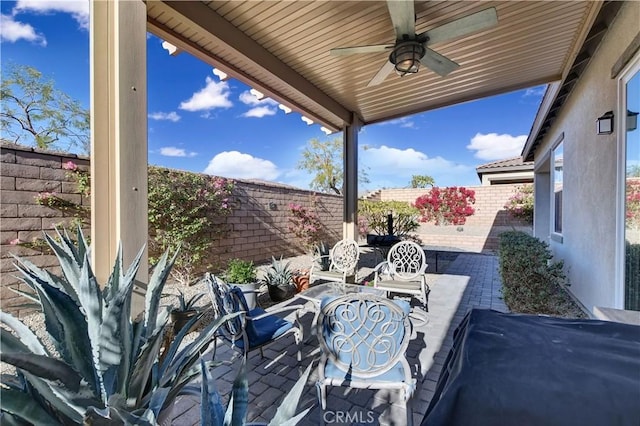 view of patio featuring ceiling fan