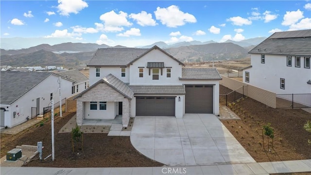 view of front facade with a mountain view and a garage