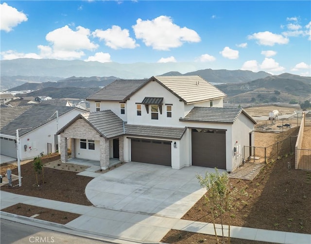 view of front of house with a mountain view and a garage