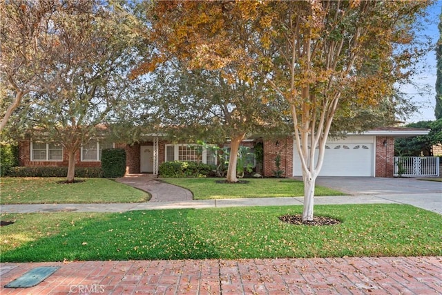 view of property hidden behind natural elements with a garage and a front lawn