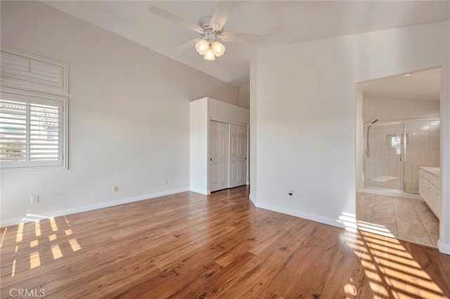 spare room featuring light hardwood / wood-style floors, ceiling fan, and lofted ceiling