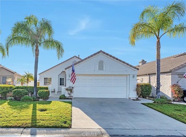 ranch-style house with a front yard and a garage