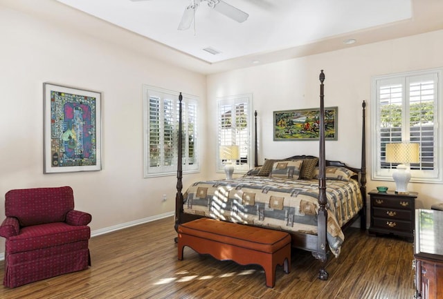 bedroom featuring dark hardwood / wood-style floors, multiple windows, and ceiling fan