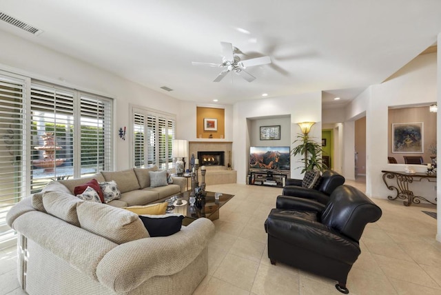 tiled living room with ceiling fan