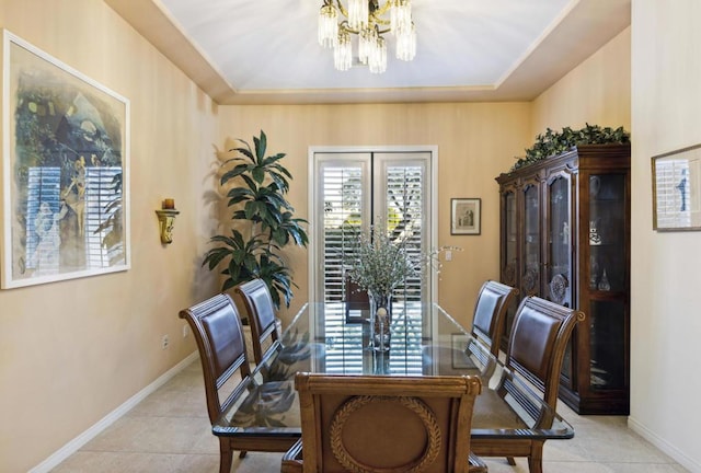 tiled dining space with a notable chandelier