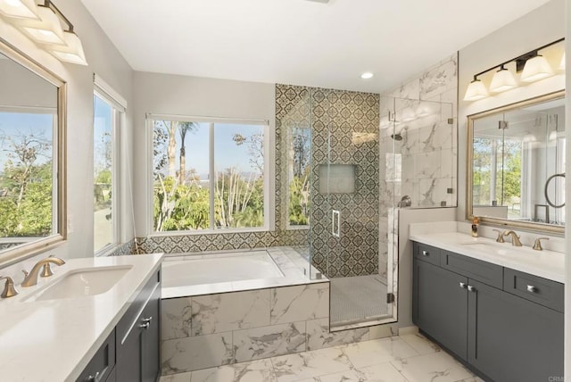 bathroom featuring vanity and independent shower and bath