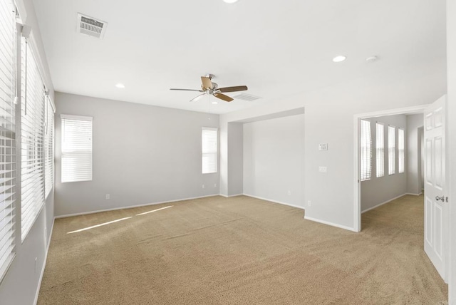 carpeted empty room featuring ceiling fan