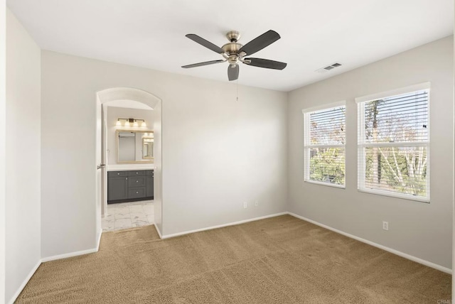 unfurnished room featuring light carpet and ceiling fan