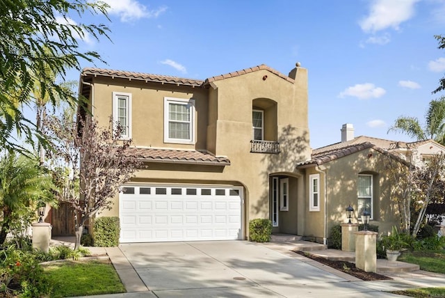 mediterranean / spanish home with a garage