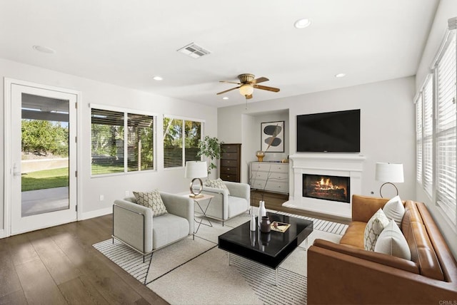 living room with hardwood / wood-style flooring, ceiling fan, and a healthy amount of sunlight