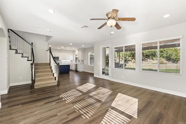 interior space with ceiling fan and dark hardwood / wood-style flooring