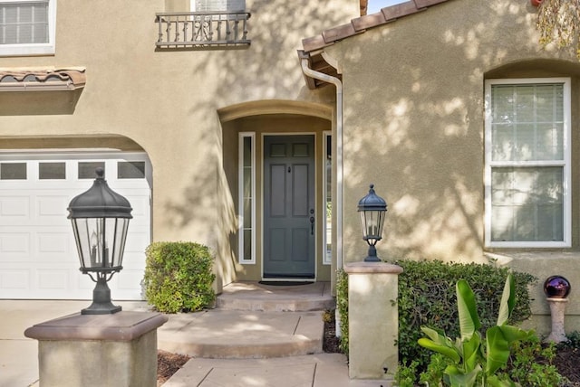 view of exterior entry with a garage