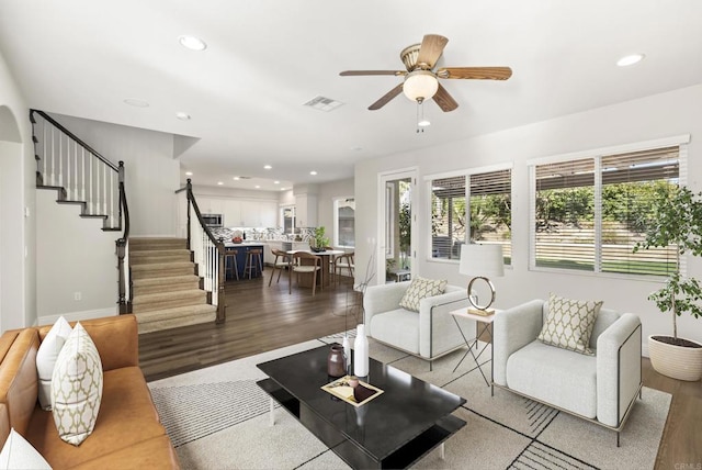 living room featuring ceiling fan and wood-type flooring