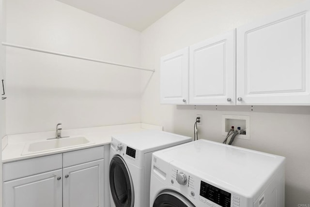 laundry room featuring separate washer and dryer, sink, and cabinets