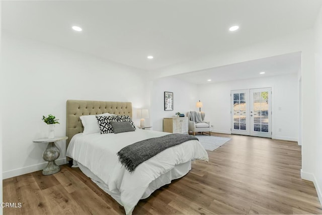 bedroom with french doors and light wood-type flooring