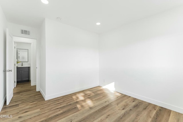 spare room with light hardwood / wood-style flooring