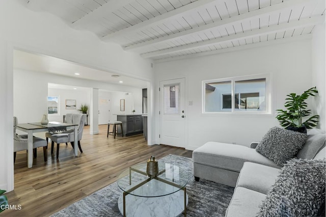 living room with wood ceiling, beamed ceiling, and dark wood-type flooring