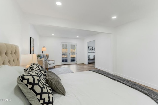 bedroom with hardwood / wood-style floors, access to outside, and french doors