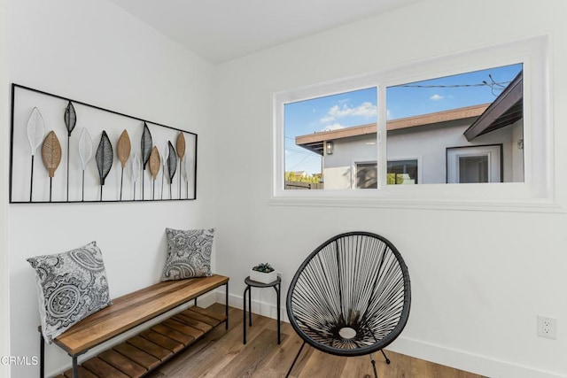 living area with hardwood / wood-style flooring